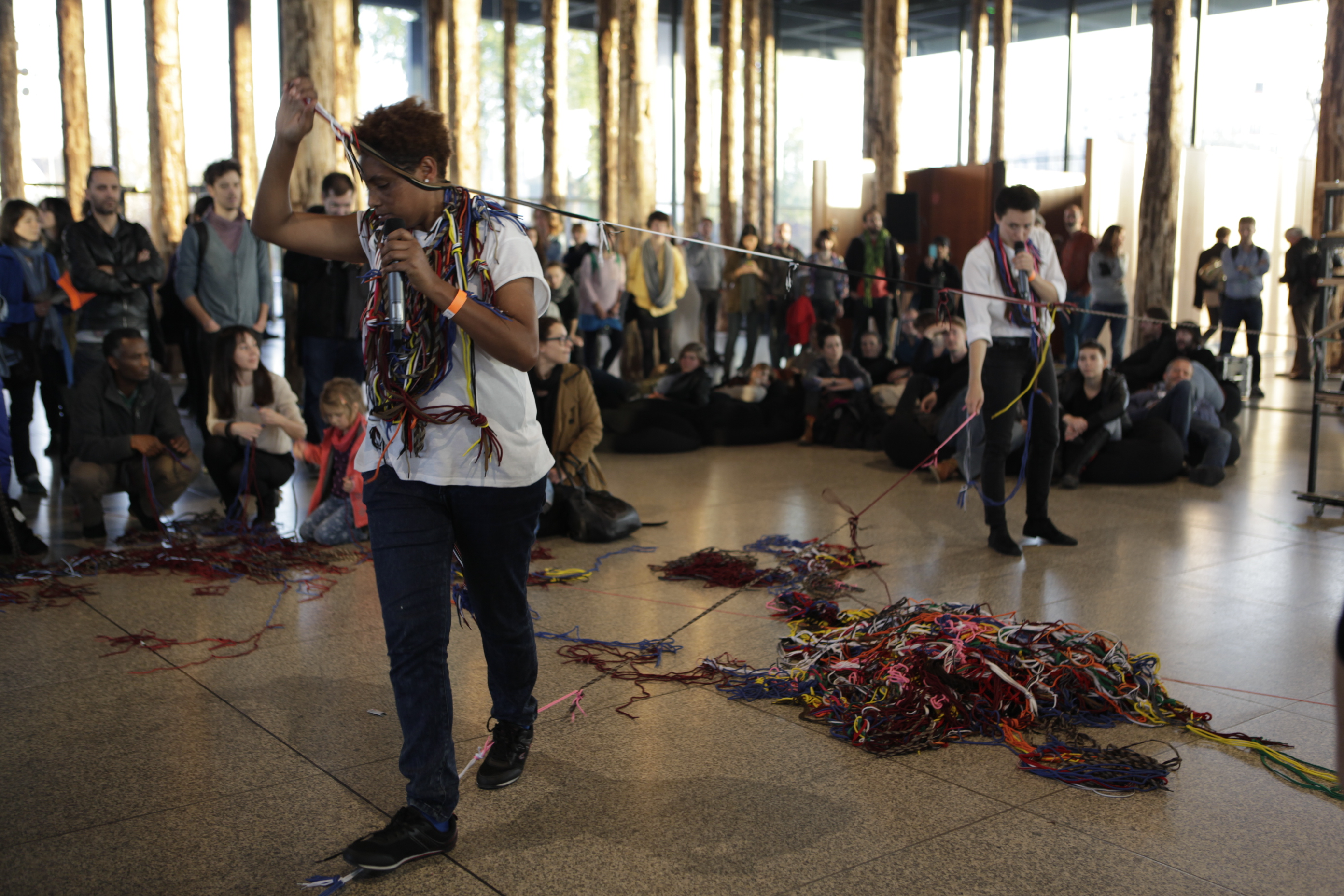 Poetry performance by Mihret Kebede and Rike Scheffler, accompanied by Simon Bauer (harp) and Claudio Puntin clarinet) at the Festival of Future Nows, festival by the Institut für Raumexperimente, UdK Berlin held within the installation David Chipperfield – Sticks and Stones at the Neue Nationalgalerie, Berlin, Germany, 2014. Photo: Institut für Raumexperimente, UdK Berlin